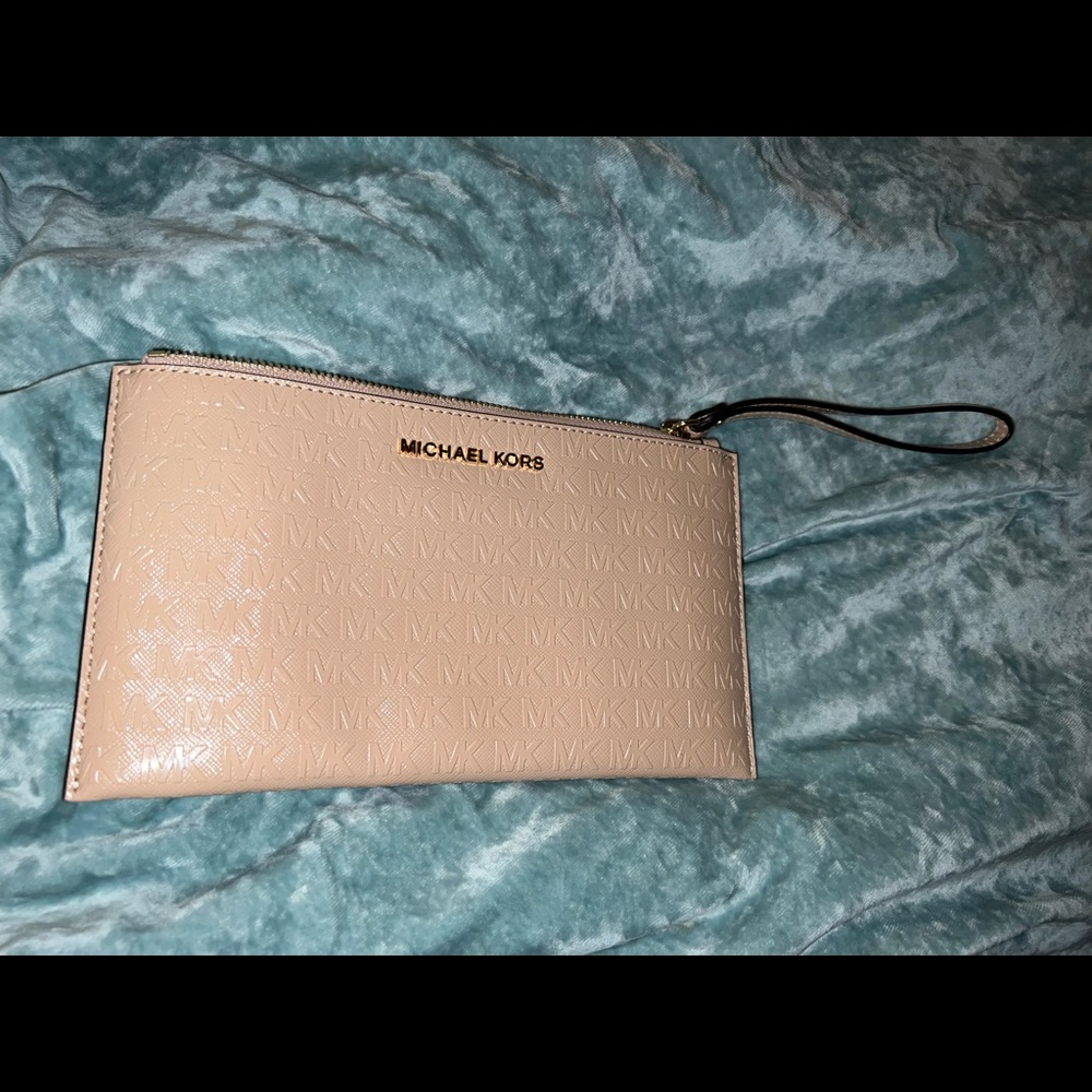 Medium logo wristlet. Peach color. Brand new!